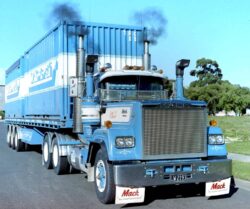 Mainfreight Mack Super Liner tractor under a tri-axle semi trailer hauling containers. New Zealand 1980s Auckland "Angel of Darkness' LW2193