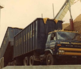 Nissan Diesel dump truck on site, ready for heavy material transport. Heavy Nissan Diesel dump truck used for transporting materials at a construction site.