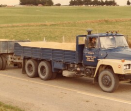 test run to see what happens Heavy-duty flatbed truck on rural road in New Zealand.