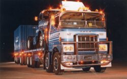 Shot at the Alexandra Blossum Festival in the early '80s, 'Donna Blue' - JJ2090 - was one of a number of Mack's that helped stamp the Mainfreight brand into public awareness with an on-road presence that was a hallmark of the company. One of the most photographed trucks of the era, this eight-wheeler replete with alloy bull-bars was at the forefront of the deregulated industry which had unleashed the full potential of the road transport industry, after decades of rail-imposed restrictions. Mainfreight founders Neil Graham, Bruce Plested and Howard Smith were visionaries and spear-headed the way with a freight-forwarding operation that has expanded operations far beyond New Zealand shores...